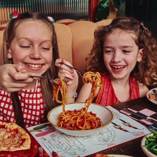 Children eating pasta together at Zizzi